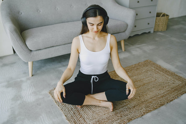 woman listening to guided meditation on headphones