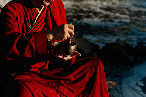 monk playing a singing bowl