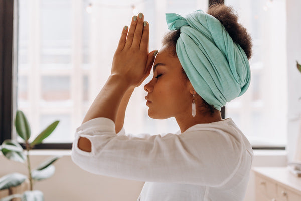 Woman in White Long Sleeve Shirt With Blue Towel on Head Perceiving Holistic Health