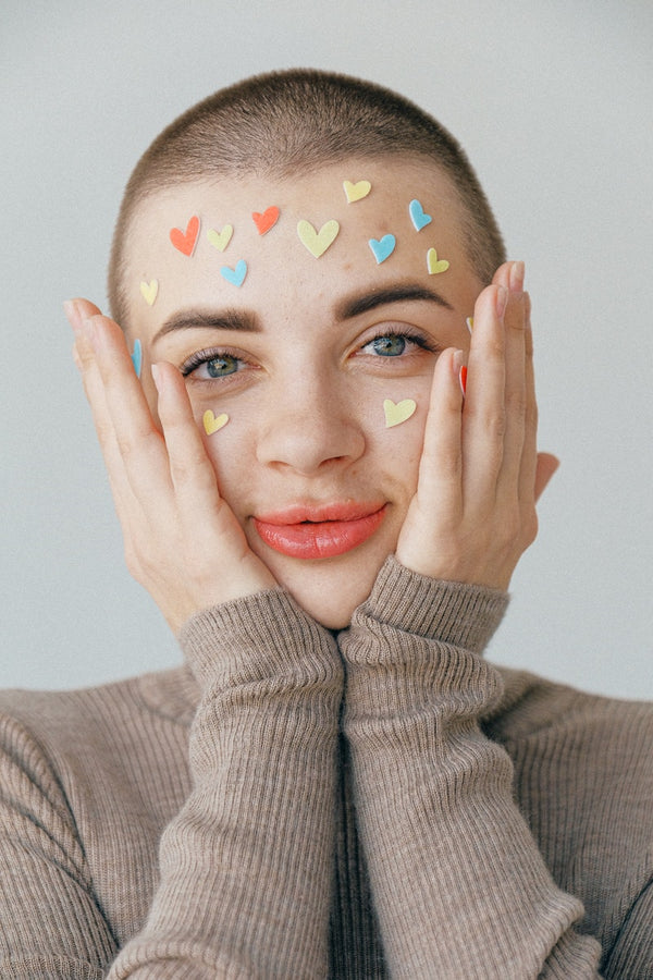 Young positive woman with many stickers on face