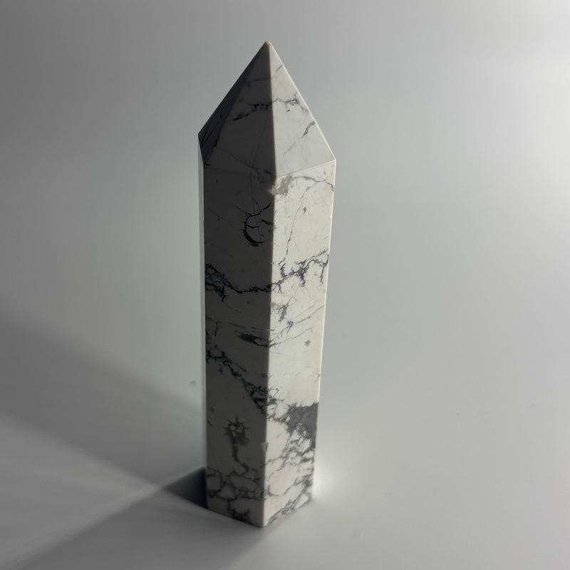 Marble obelisk on a gray background