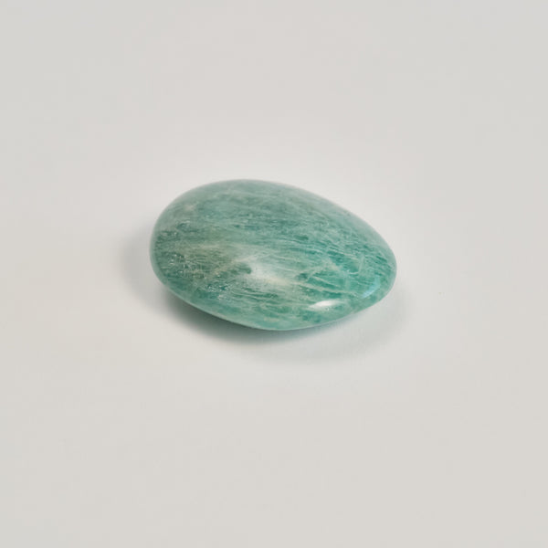 Amazonite stone on a white floor