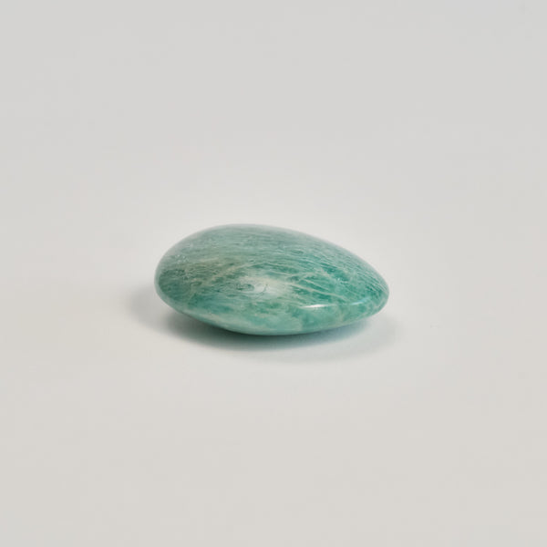 Amazonite stone on a white floor