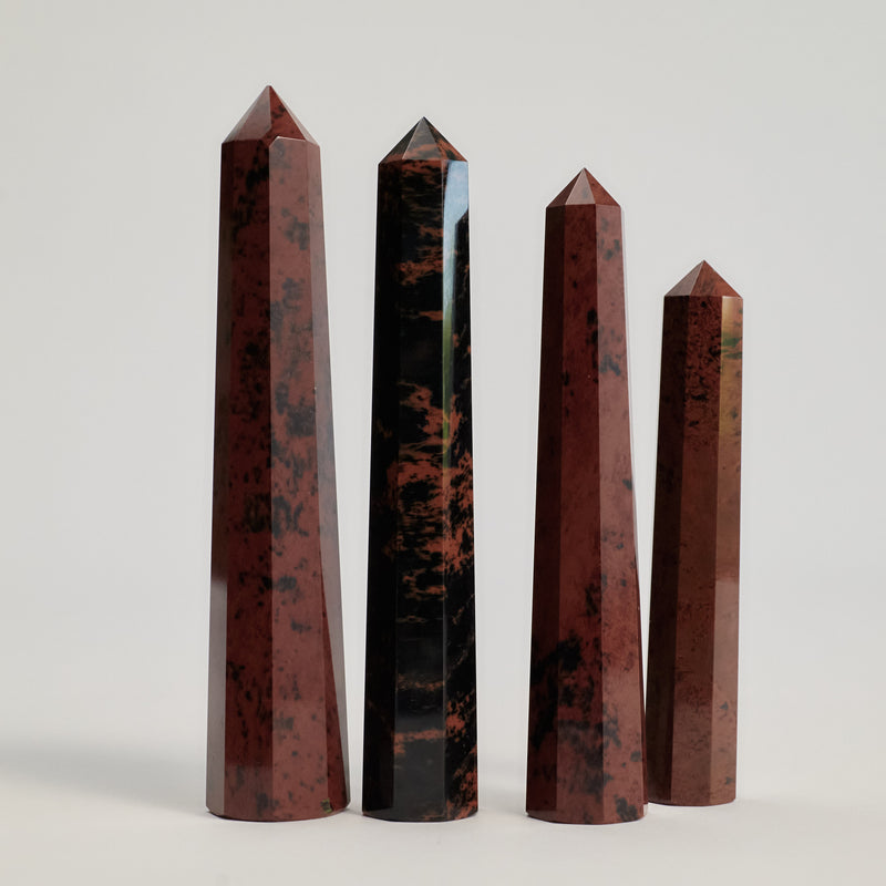 A couple of Mahogany Obsidian Tower stones on a white floor