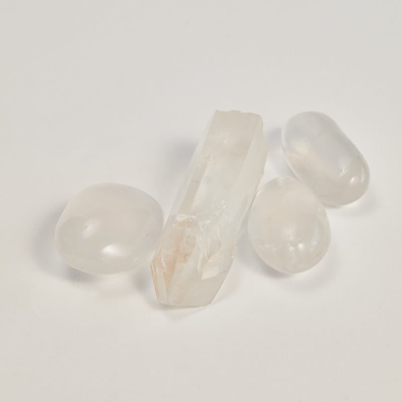 A couple of Clear Quartz stones on a white floor