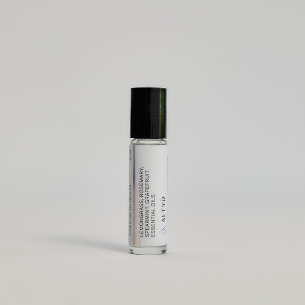 Awake Essential Oil Roller package with its ingredients shown on a white floor