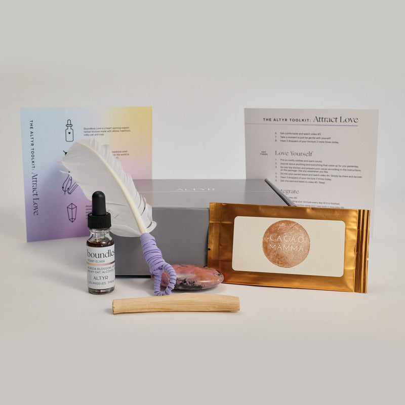  Altyr Toolkit: Attract Love box with simple aura colored design including Boundless Love Heart Elixir Herbal Tincture, Ceremonial Grade Cacao, Rhodonite Gemstone, Palo Santo and Smudging Feather