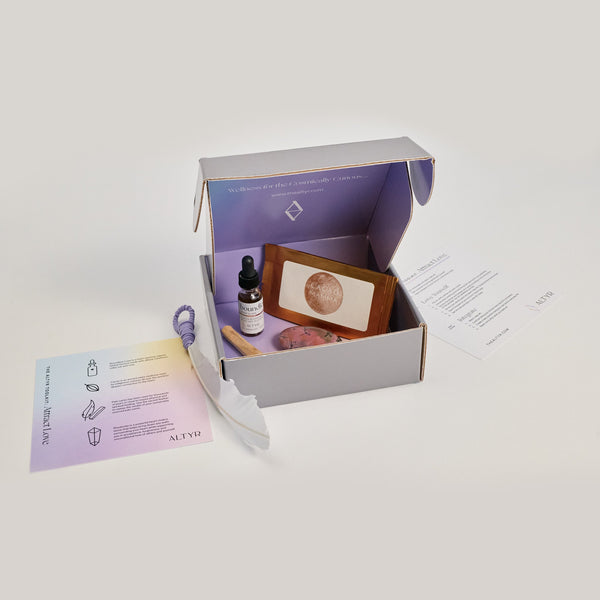  Altyr Toolkit: Attract Love box with simple aura colored design including Boundless Love Heart Elixir Herbal Tincture, Ceremonial Grade Cacao, Rhodonite Gemstone, Palo Santo and Smudging Feather