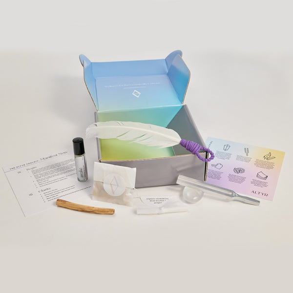 Altyr Toolkit: Manifest Now box with simple aura colored design including Clear Quartz Crystal, Tuning Fork 512 Hz, Palo Santo and Smudging Feather, I WILL Herbal Tea, Clarity Organic Essential Oil Roller, and Release papers